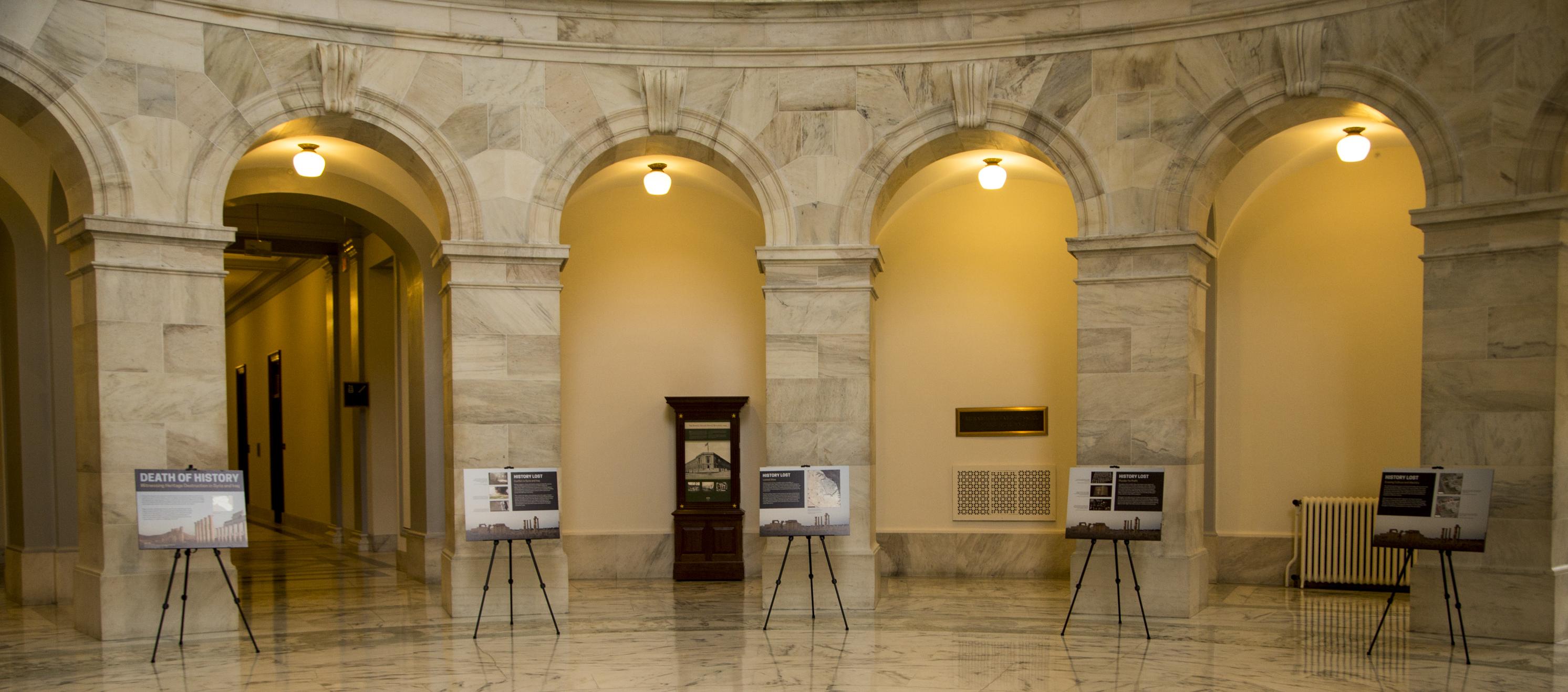 Large information panel sit in easels in the rotunda of the capitol building 
