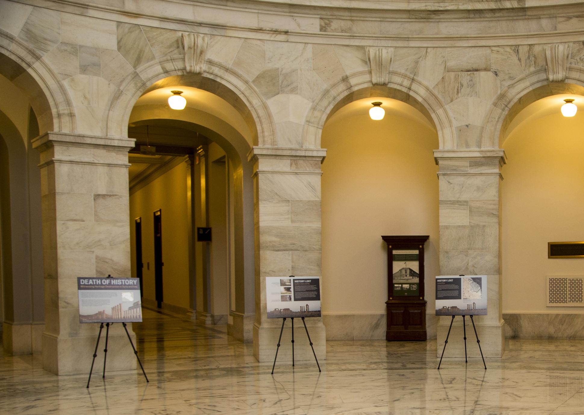 Large information panel sit in easels in the rotunda of the capitol building 