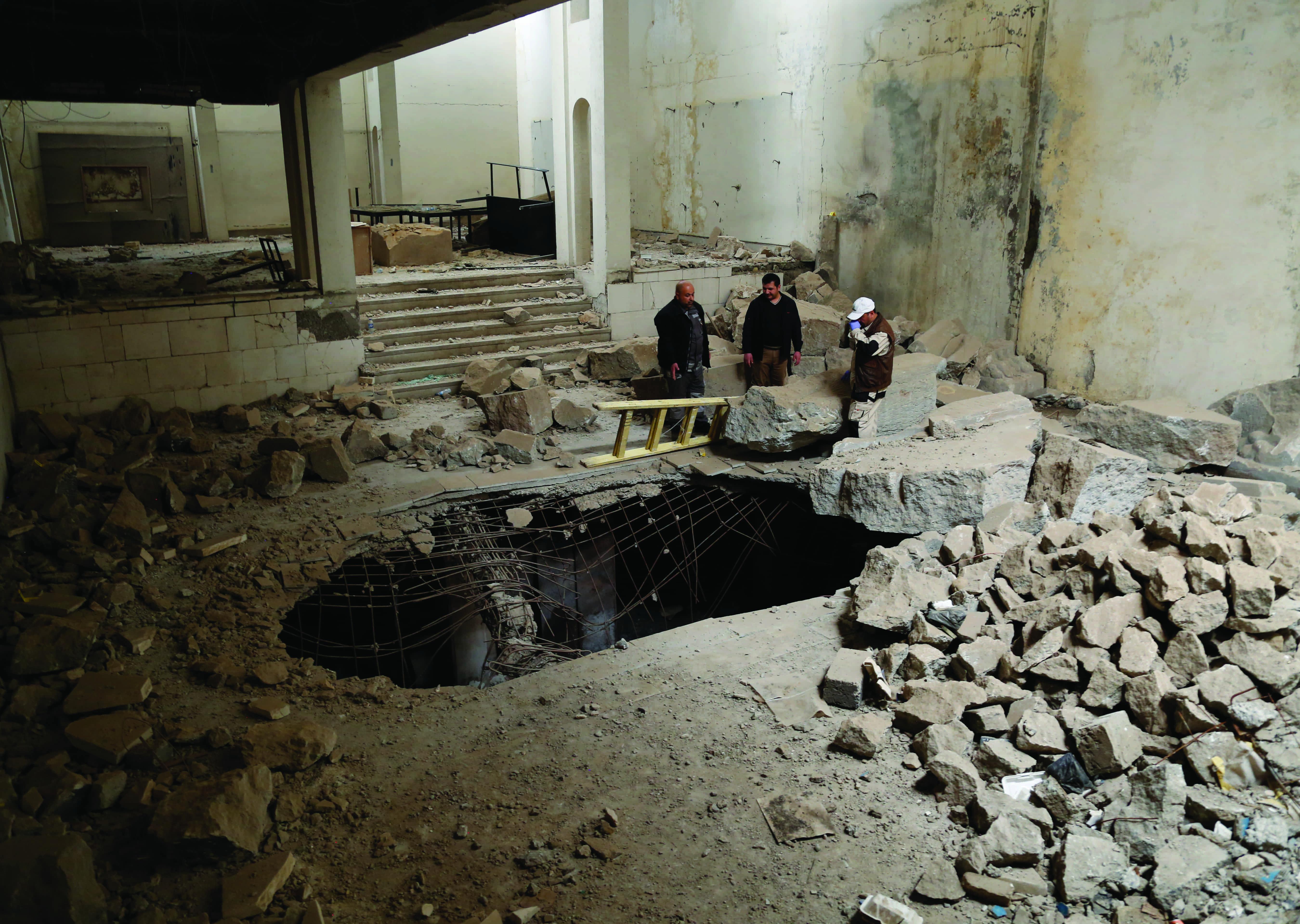 Hole in the center of a room surrounded by debris.