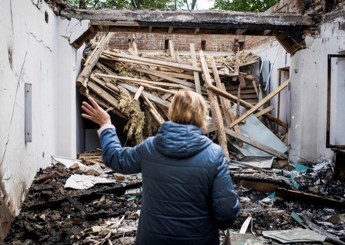 Museum director Nataliia Micay describes the damage to the Hryhorii Skovoroda Literary Memorial Museum after a Russian rocket strike. Pete Kiehart for NBC News