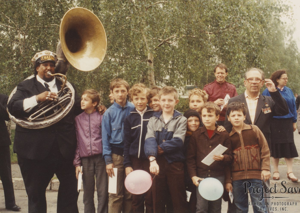 A member of the Young Tuxedo Brass Band from New Orleans poses with Ukrainian youth in Kyiv, May 1990.   Photo by Ruth Thomasian, courtesy of Project SAVE Armenian Photograph Archives